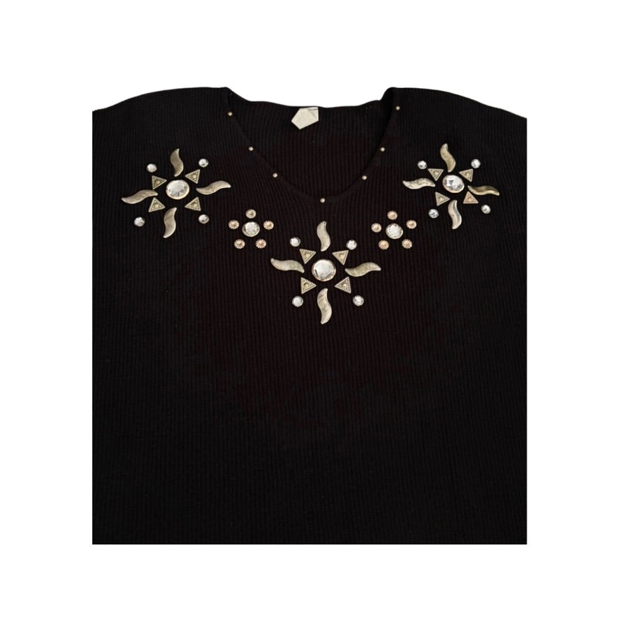 Black top with decorative silver patterns on a white background