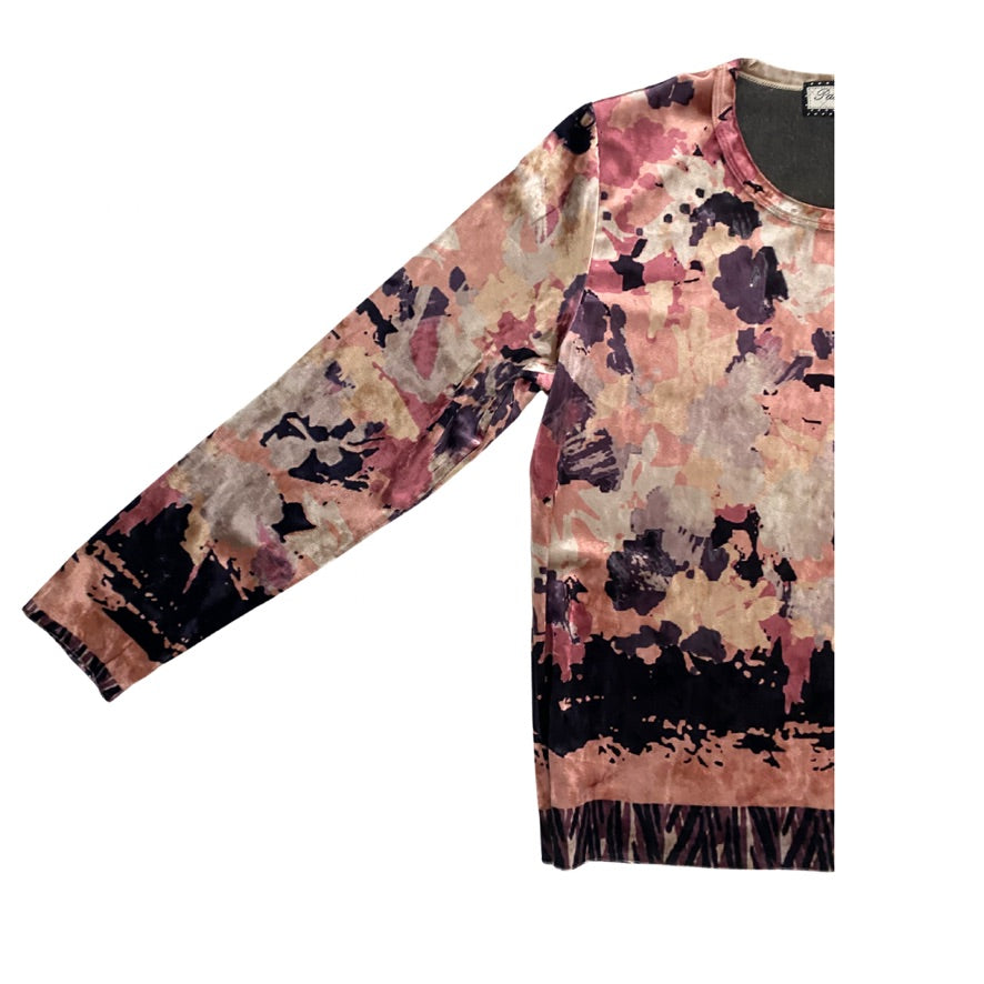 Floral patterned long-sleeve top on a white background