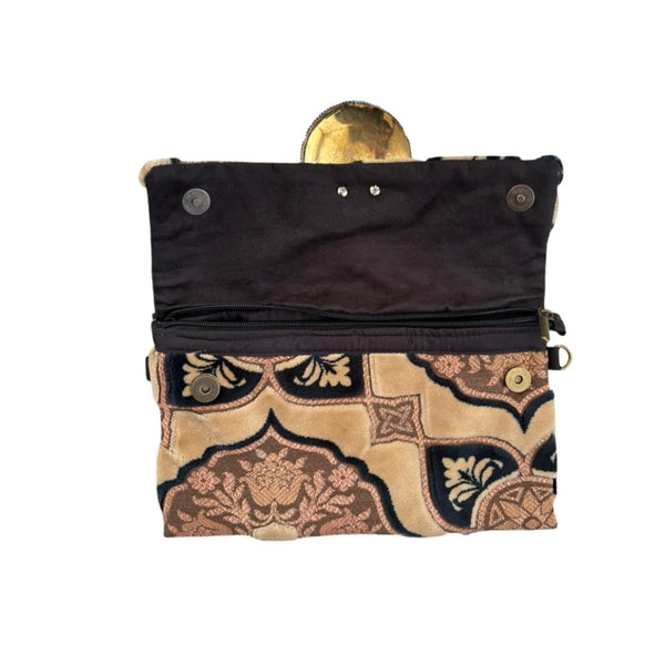 Black pouch with gold and beige patterned flap on a white background