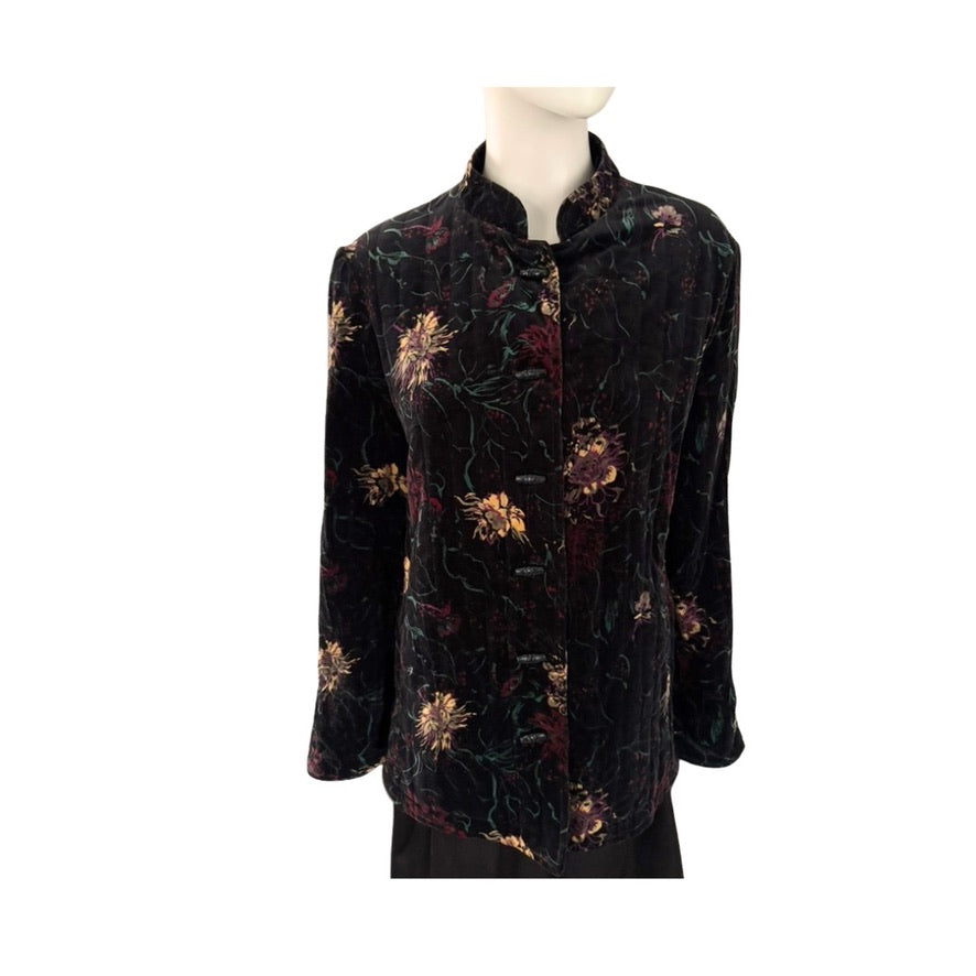 Black floral patterned blouse on a mannequin against a white background