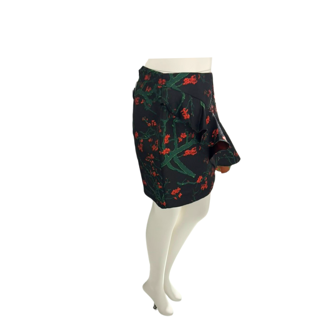 Black skirt with red and green floral pattern on a mannequin against a white background
