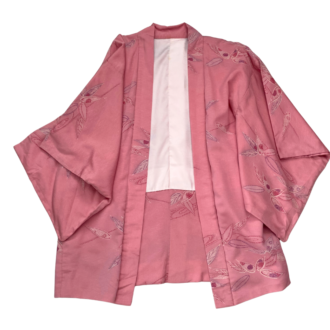 Pink kimono with floral patterns on a white background