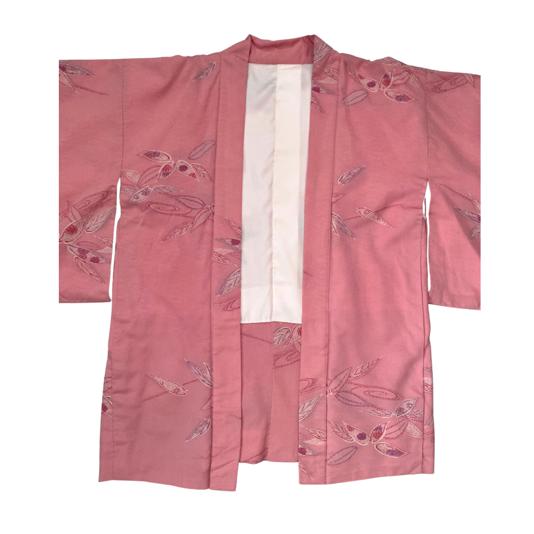 Pink kimono with floral patterns on a white background