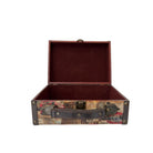 Open vintage-style suitcase with multicolored pattern on a white background