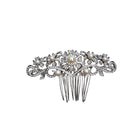 Decorative hair comb with pearls and crystals on a white background