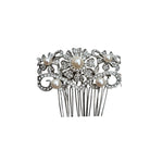 Decorative hair comb with pearls and crystals on a white background