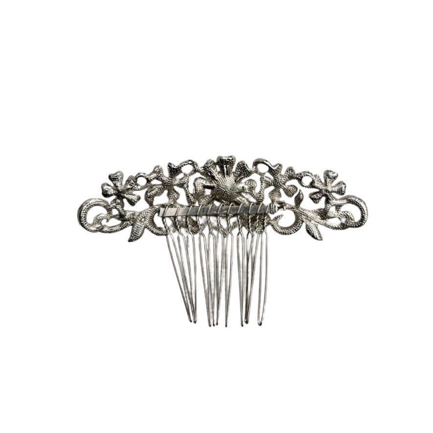 Decorative silver hair comb on a white background