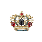 Decorative brooch with pearls, red and blue gemstones on a white background