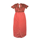 Coral evening gown with lace detailing on a white background