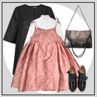 Pink dress with black top, black shoes, and silver handbag on a light gray background