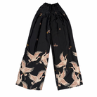 Black pants with crane pattern on a white background