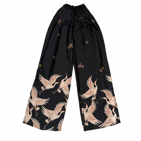 Black pants with crane pattern on a white background