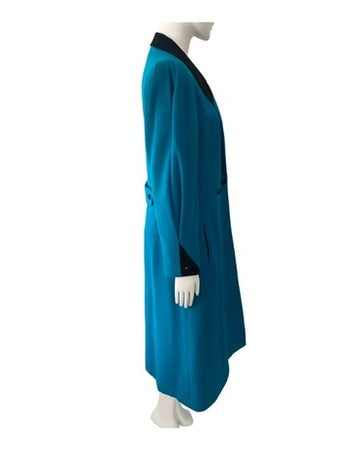 Teal dress on a mannequin against a white background