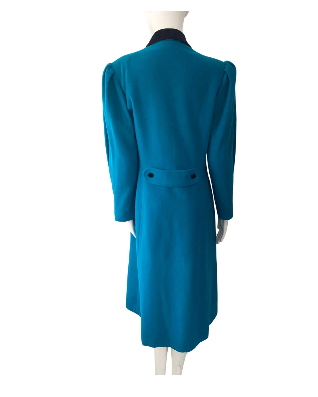 Teal coat on a mannequin against a white background