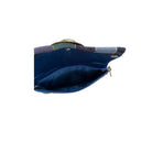 Blue lined handbag with a gold clasp on a white background