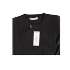 Black top with a visible brand tag on a white background