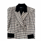 Plaid blazer with black trim on a white background