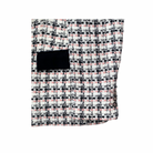 Patterned fabric with a black pocket on a white background