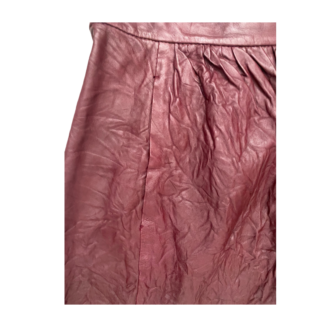 Close-up of a burgundy textured leather skirt pocket on a white background