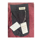 Black garment with Zadig & Voltaire tags on a burgungy fabric background