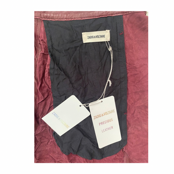 Black garment with Zadig & Voltaire tags on a burgungy fabric background