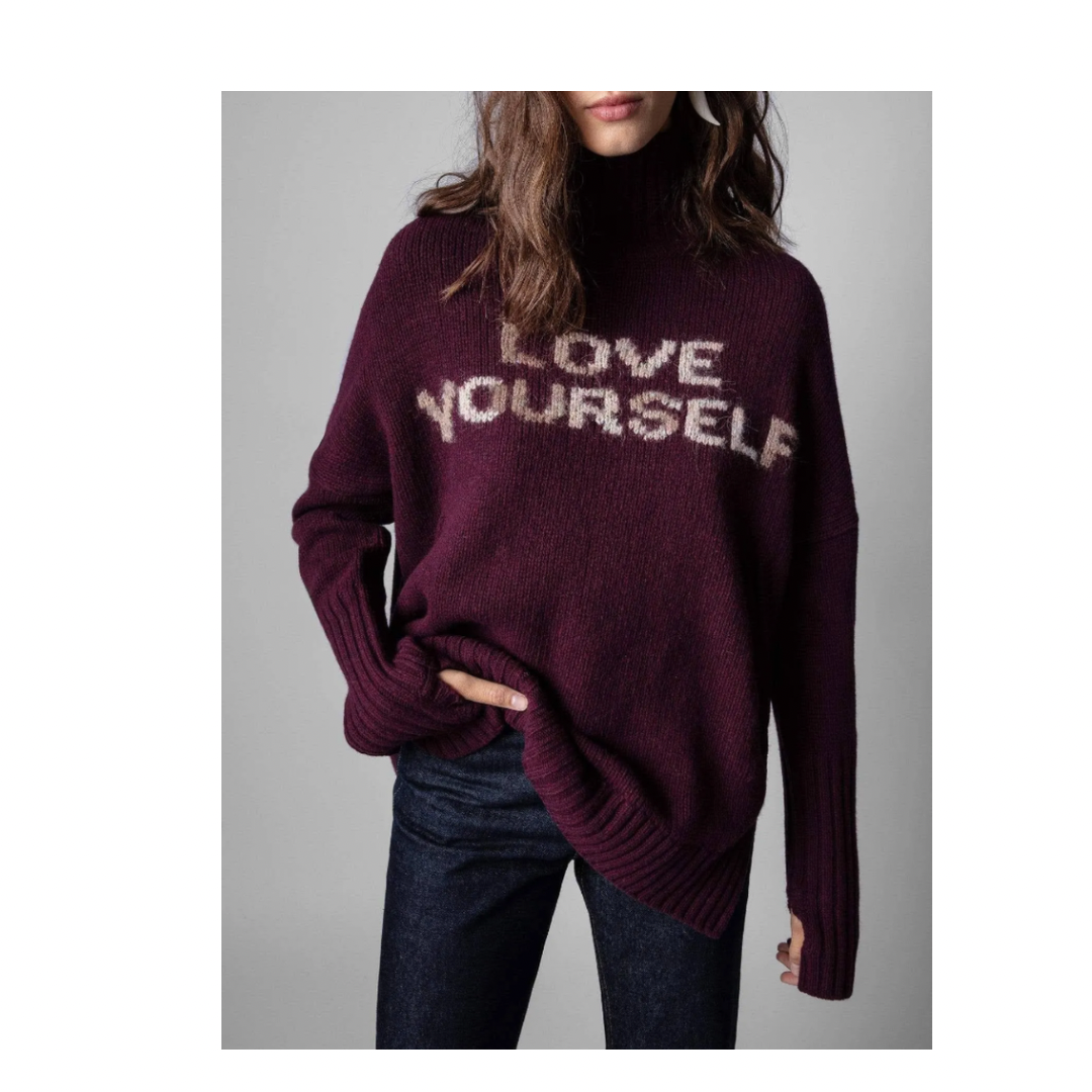 Person wearing a maroon sweater with 'LOVE YOURSELF' text on a gray background