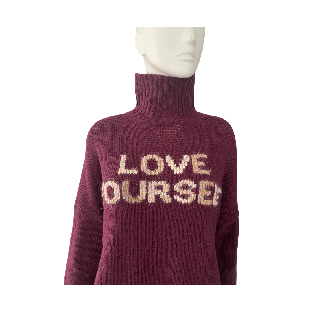 Burgundy sweater with 'LOVE OURSEL' text on a mannequin against a white background
