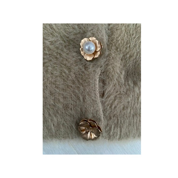 Gold buttons with a pearl on a textured cardigan