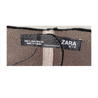 Zara label on a brown fabric background