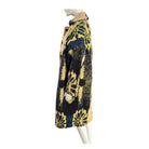 Mannequin wearing a patterned coat with yellow and blue design on a white background