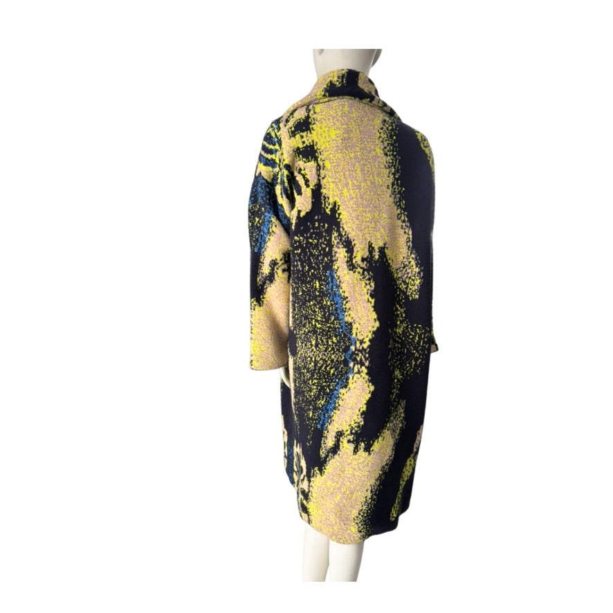 Mannequin wearing a black and yellow patterned dress on a white background