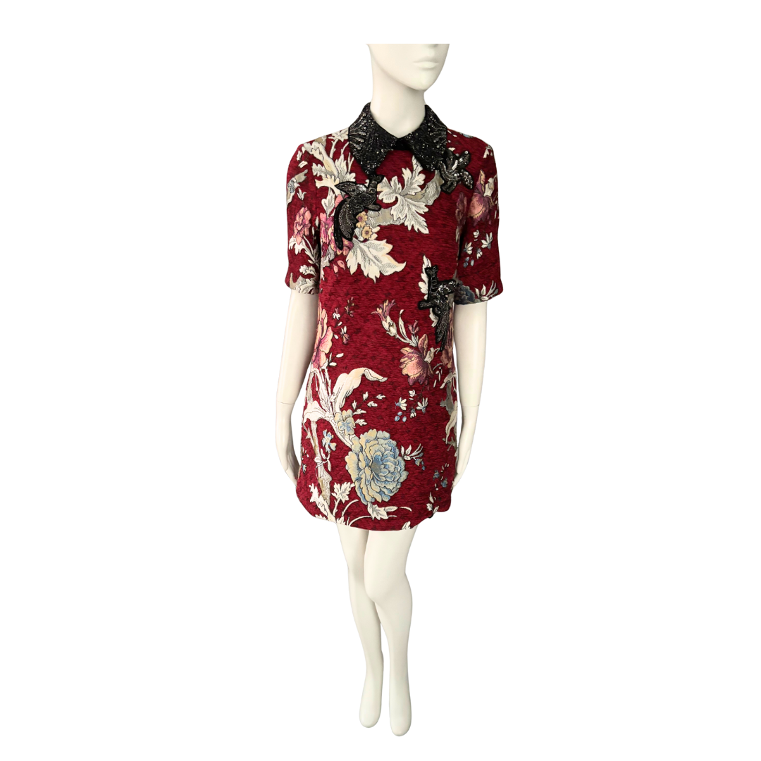 Red floral dress on a mannequin against a white background