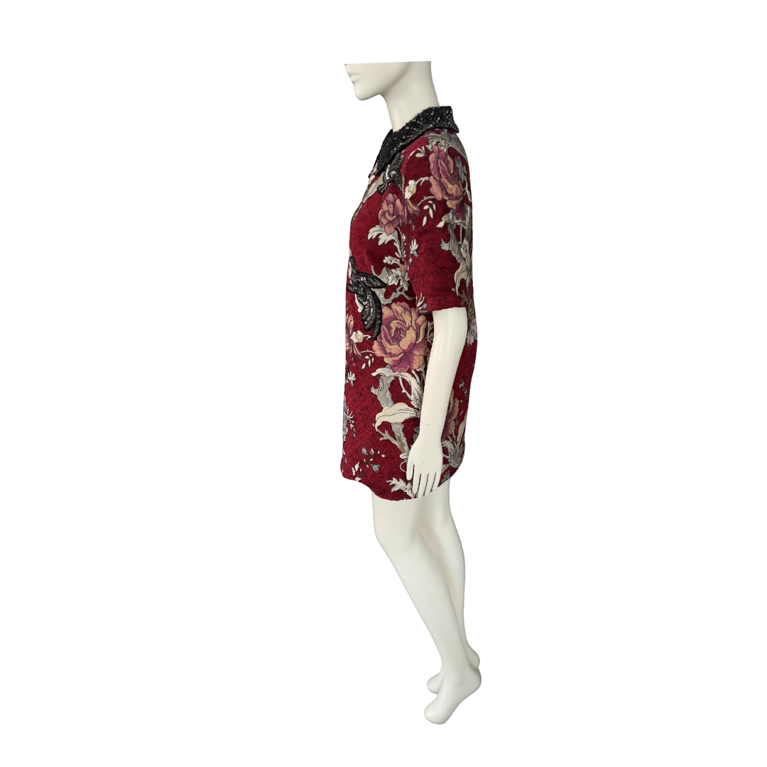 Red floral dress on a mannequin against a white background