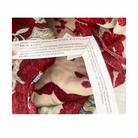 Close-up of a fabric with a floral pattern and a label on a white background