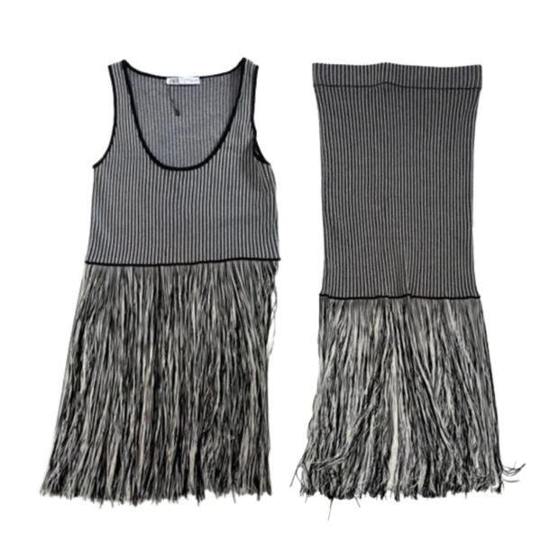 Black and white striped dress with frayed hem on a white background