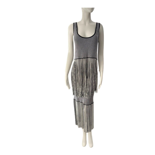 Mannequin wearing a black and white patterned dress with fringe on a white background