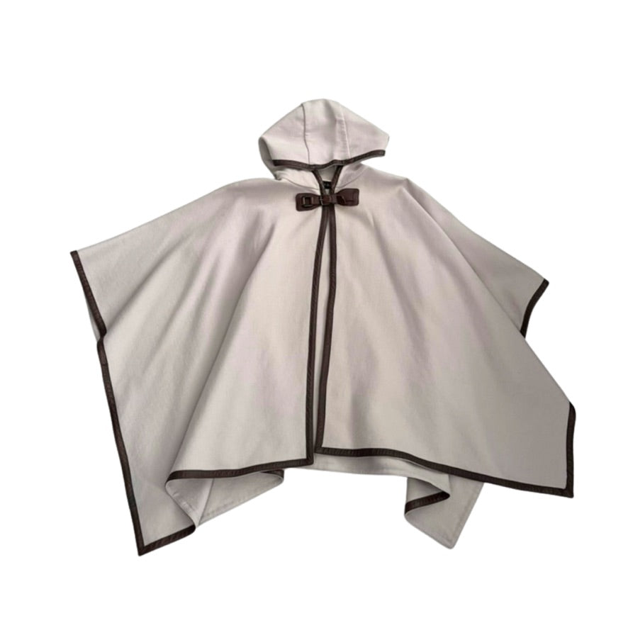 Beige cape with black trim on a white background