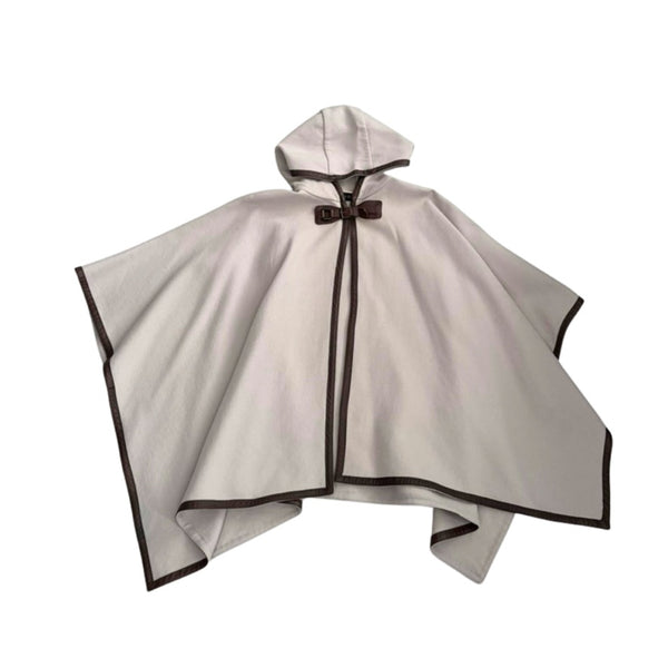 Beige cape with black trim on a white background