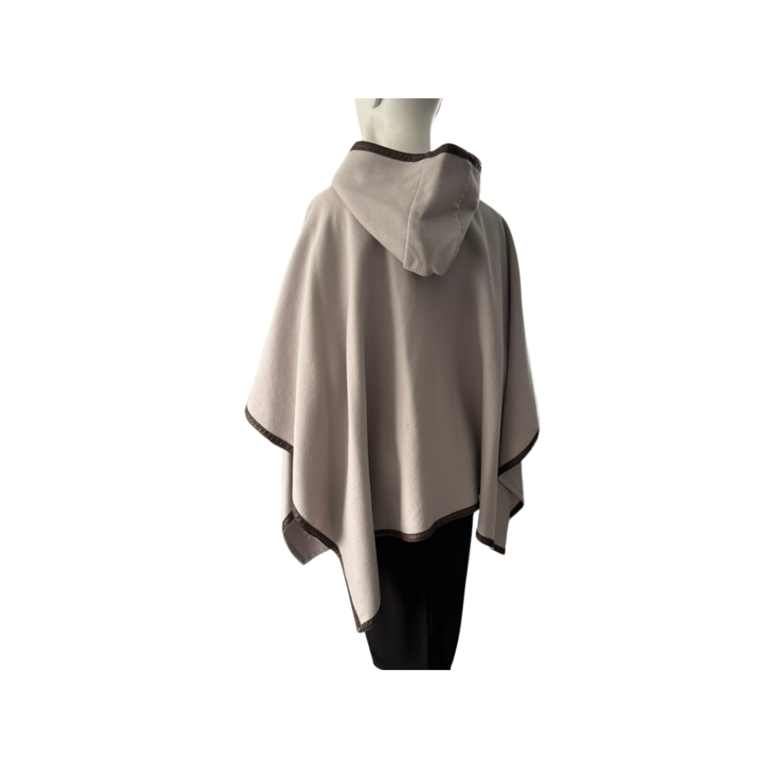 Beige hooded poncho on a mannequin against a white background