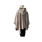 Beige hooded poncho on a mannequin against a white background