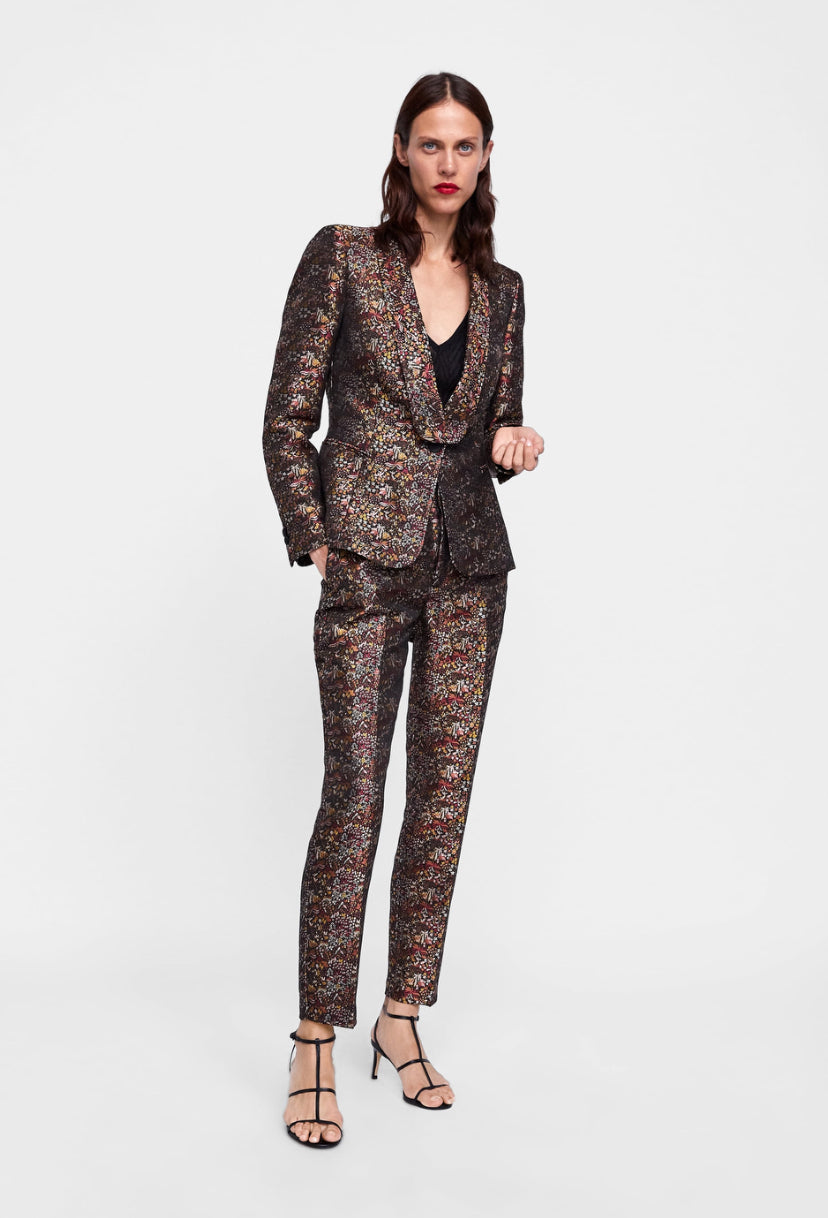 Woman wearing a patterned suit on a white background