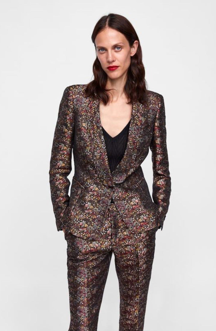 Woman wearing a floral suit on a white background