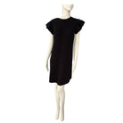 Black dress on a mannequin against a white background