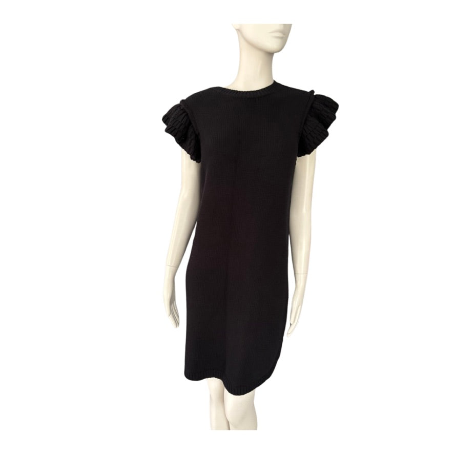 Black dress with ruffled sleeves on a mannequin against a white background