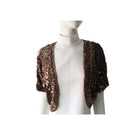 Brown sequin shrug on a mannequin against a white background