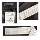 Close-up of Zara Woman clothing labels with brand name and size information.
